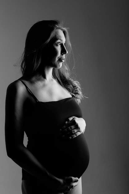 Premium Photo Caucasian Pregnant Woman Stroking Her Belly On White