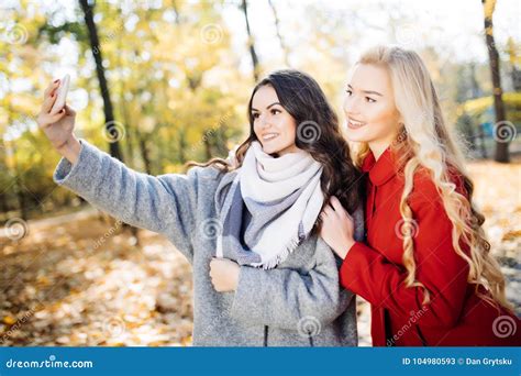 Two Beautiful Young Woman Taking Selfie In Autumn Day In Park Stock Image Image Of Face