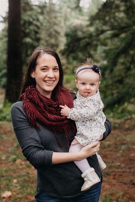 Young Mother Holding Beautiful Baby Girl By Stocksy Contributor Leah