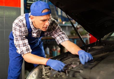 Positive Man Car Mechanician Repairing Car In Auto Repair Service Stock