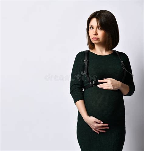 Brunette Pregnant Woman In Black Tight Dress And Massive Earrings She