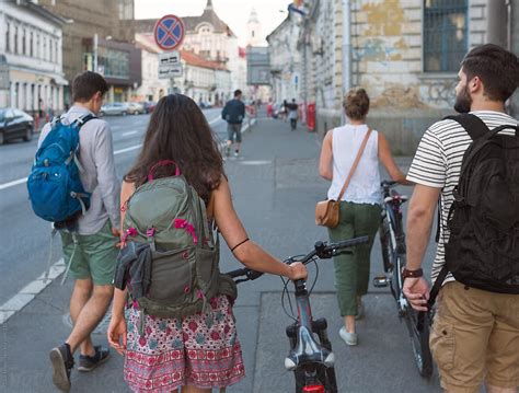 Group Of Young People Walking Through The City By Ibexmedia People