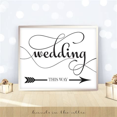 Black And White Flourish Script Wedding This Way Sign Hands In The