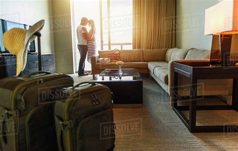 Couple Hugging In Hotel Room Stock Photo Dissolve