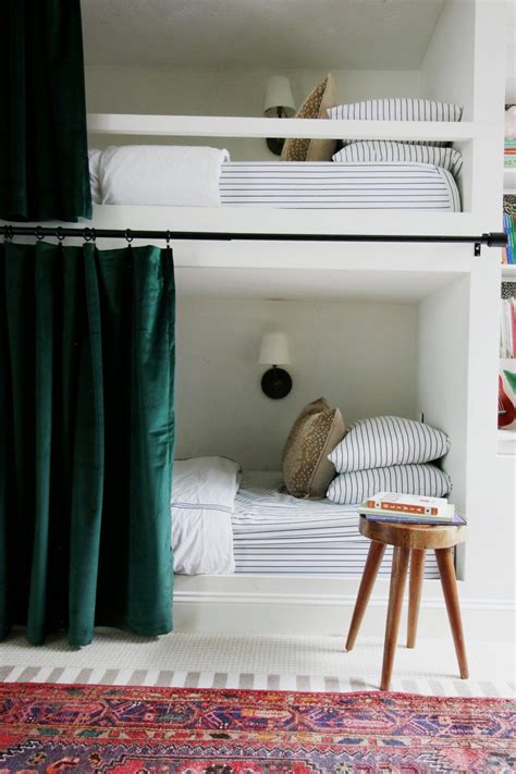 Two Bunk Beds In A Room With Green Curtains