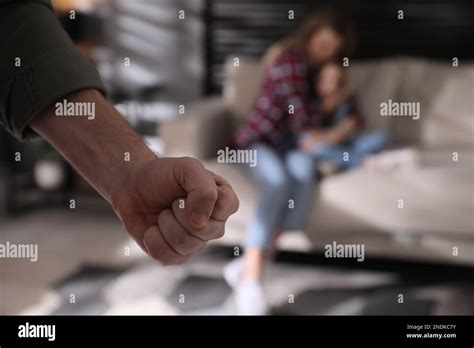 Man threatening his wife and daughter at home, closeup. Domestic