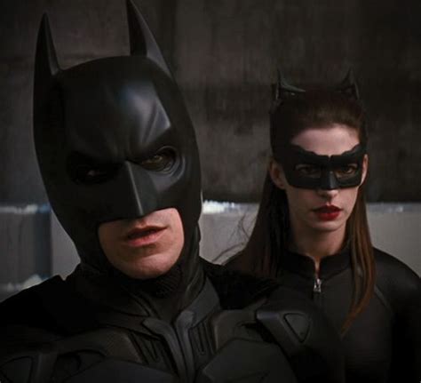 Two People Dressed Up As Batman And Catwoman Standing Next To Each Other In The Dark Knight Movie