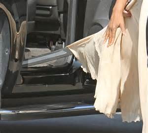 Oprah Winfrey Snags Her Cream Chiffon Skirt As She Gets Out Of Her Suv