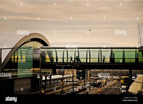 Passengers Cross A Walkway At Dublin Airport Terminal Two Stock Photo