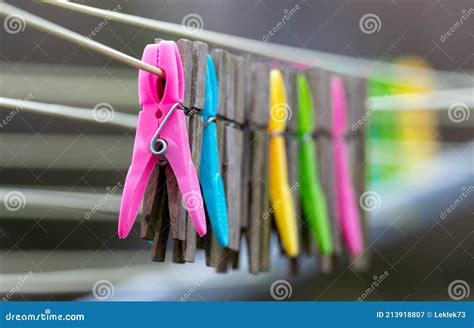 Mixture Of Plastic And Wooden Clothes Pegs Hanging From A Clothes Line