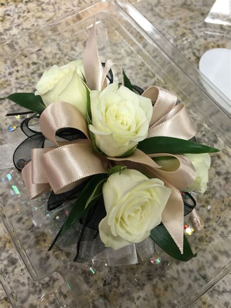 Pink gypsy bracelet with bright pink ribbon, black gyp, and white spray roses $31.49 #homecomingflowers #floristdecaturil. Wristlet corsage with white spray roses, champagne satin ...