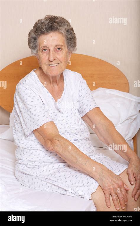 Happy Senior Woman Is Sitting In Her Bed Stock Photo Alamy