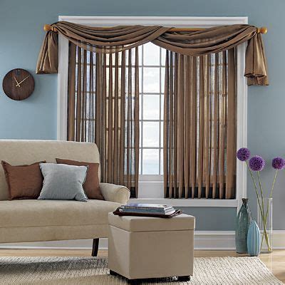 Details of white fabric roller blinds on the plastic window with wood texture in the living room. cover vertical blinds with sheer fabric # ...