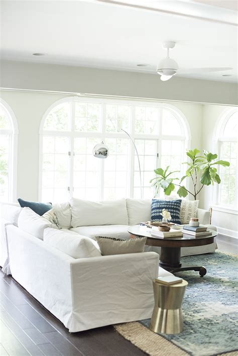 A gorgeous creamy white leather sectional sofa in a modern and relaxed lakehouse living room. How We Choose : White Slipcovered Sofas - Room for Tuesday ...
