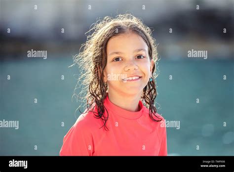 Beautiful Little Girl With Wet Hair Smiling And Looking At Camera At