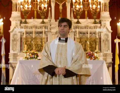 Robed Priest Standing At The Altar Of A Church Stock Photo Alamy