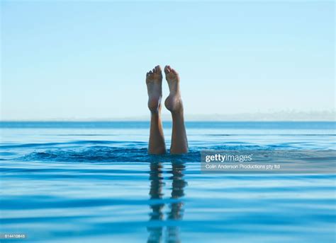 Feet Of Caucasian Girl Swimming In Tropical Ocean Photo Getty Images