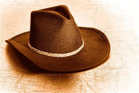 Cowboy Hat On Leather Sepia Photograph By Olivier Le Queinec Fine