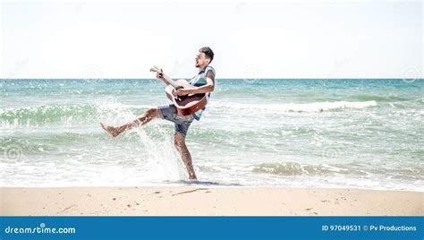 Young Man With Acoustic Guitar On The Beach Stock Image Image Of