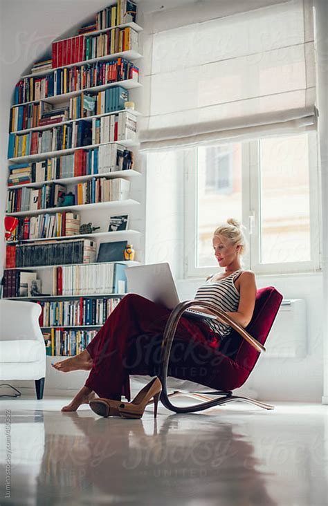 Blonde Woman Using Her Laptop At Home By Lumina Stocksy United