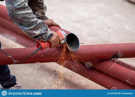 Construction Workers Are Using Grinding Machines On Large Steel Pipes