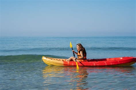 Woman In Life Jacket Paddling A Kayak Boat In Sea Stock Image Image
