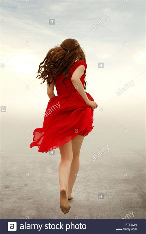 Download This Stock Image Woman In Red Dress Running Away Fttemn From Alamys Library Of
