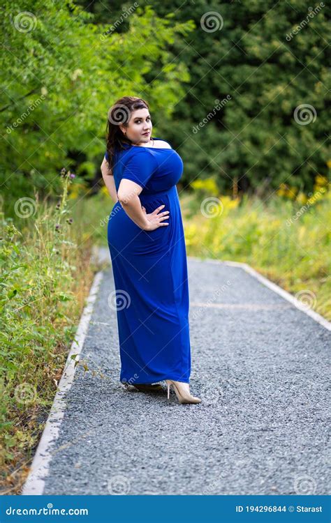 Plus Size Fashion Model In Blue Dress With A Deep Neckline Outdoors Beautiful Fat Woman With