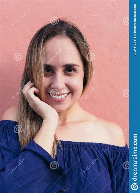Woman With Her Hand On Her Chin Looking At The Camera Stock Image