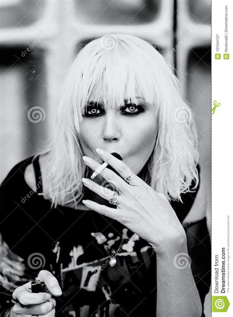 Portrait Of Stylish Blonde Grunge Young Woman Smoking Cigarette Stock