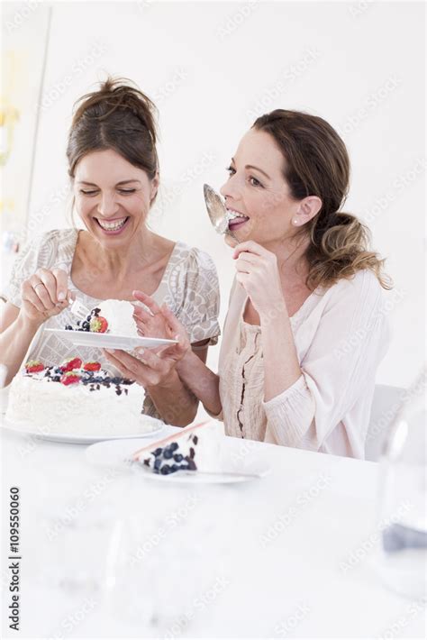 Mature Woman Eating Cake Licking Cake Server Smiling Stock Photo Adobe Stock