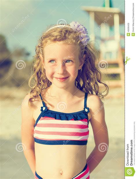 Portrait Of Happy Little Girl On The Beach Stock Photo