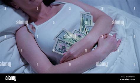 Woman Sleeping On Bed With Bundle Of Currency Notes Stock Photo Alamy