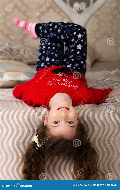 Little Girl Lying On The Bed Upside Down Stock Photo Image Of Sofa