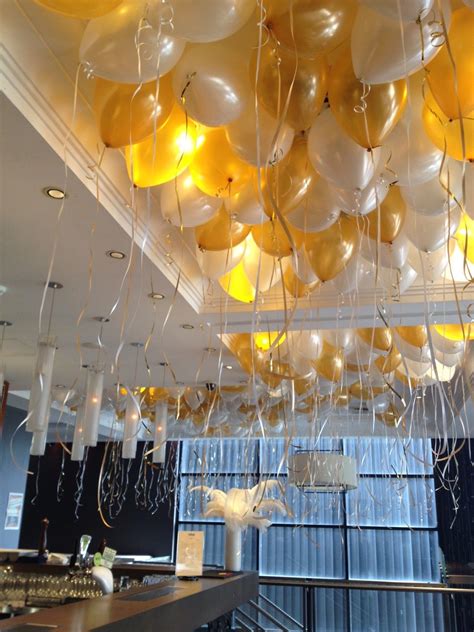 Many Balloons Are Hanging From The Ceiling In An Office Setting With
