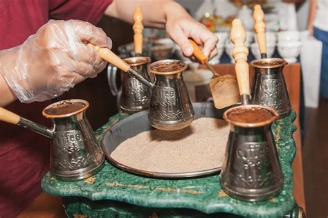 Premium Photo Woman Makes Turkish Coffee On A Coffee Machine With