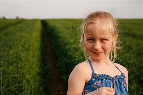 Portrait Of A Little Girl In A Field Of Barley By Stocksy