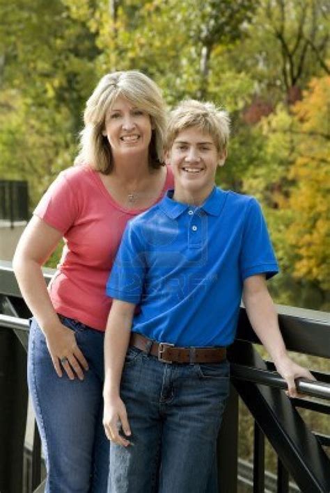 When it's time to choose. A blond mom and teenage son posing near a line of trees ...