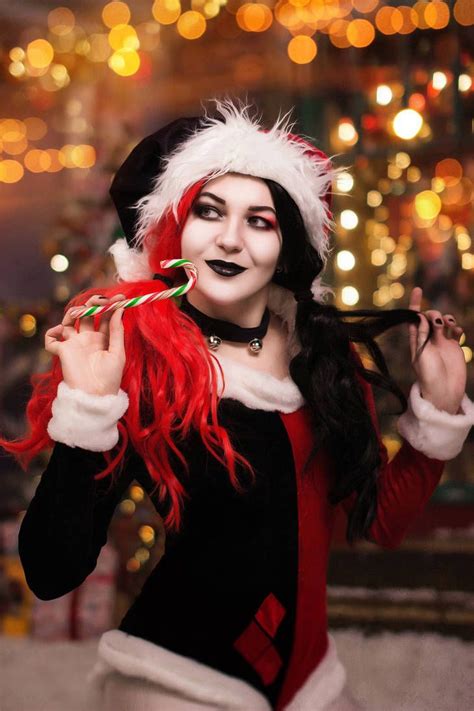 A Woman Dressed As Santa Clause Holding A Candy Cane In Her Hand And