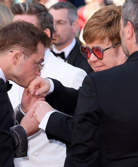 taron egerton kisses elton john s hand and ties his laces at rocketman premiere irish mirror