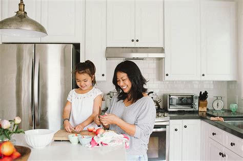 Mom And Daughter Making A Snack Together In Kitchen By Stocksy Contributor Kristin Rogers