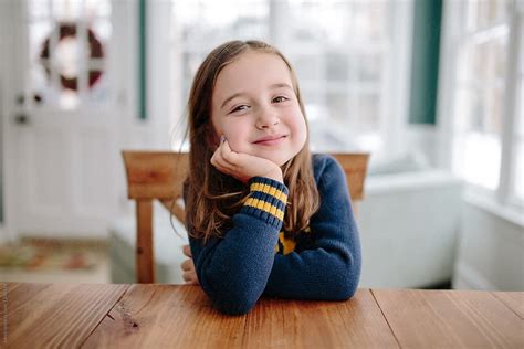 Cute Young Girl Smiling At Table By Stocksy Contributor Jakob Lagerstedt Stocksy