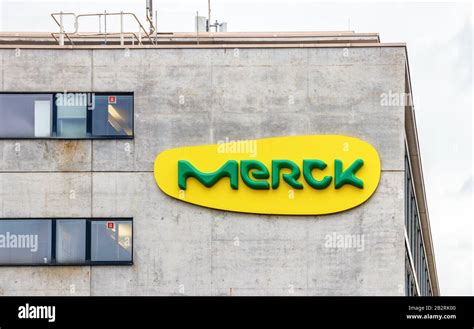 Large Yellow Green Merck Logo At A Concrete Wall Of A Merck Building