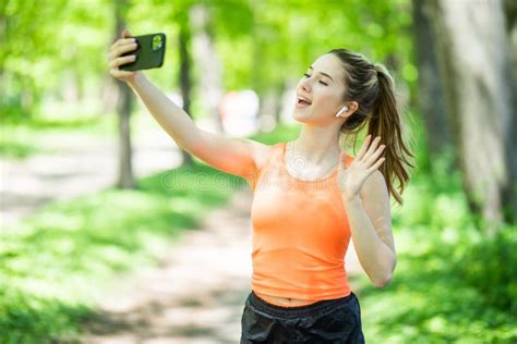 Selfie Portrait Young Cheerful Fit Woman In Sports Top Smiling Outdoors