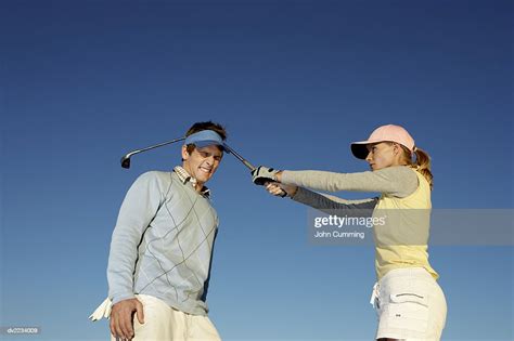 Woman Hitting A Man Over The Head With A Golf Club Photo Getty Images