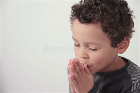 Boy Praying To God With Hands Held Together Stock Photo Stock Photo