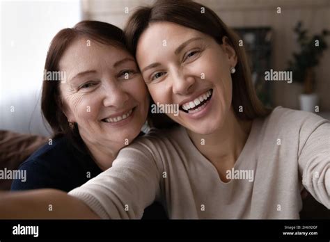 Head Shot Portrait Happy Woman With Mature Mother Taking Selfie Stock