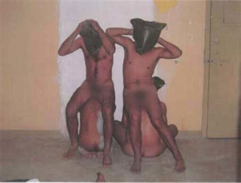 Naked And Hooded Iraqi Detainees Forced To Sit On One Another