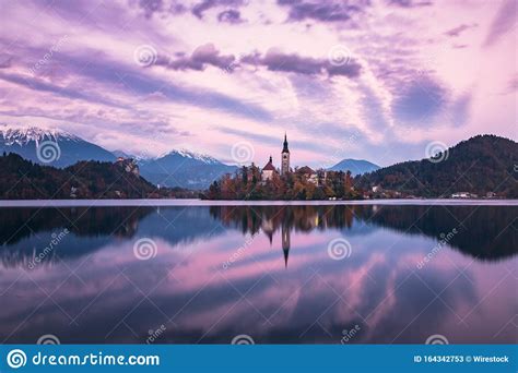 Historic Castle Surrounded By Trees Reflected In The Lake Under The