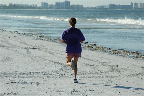 fit woman running at the beach